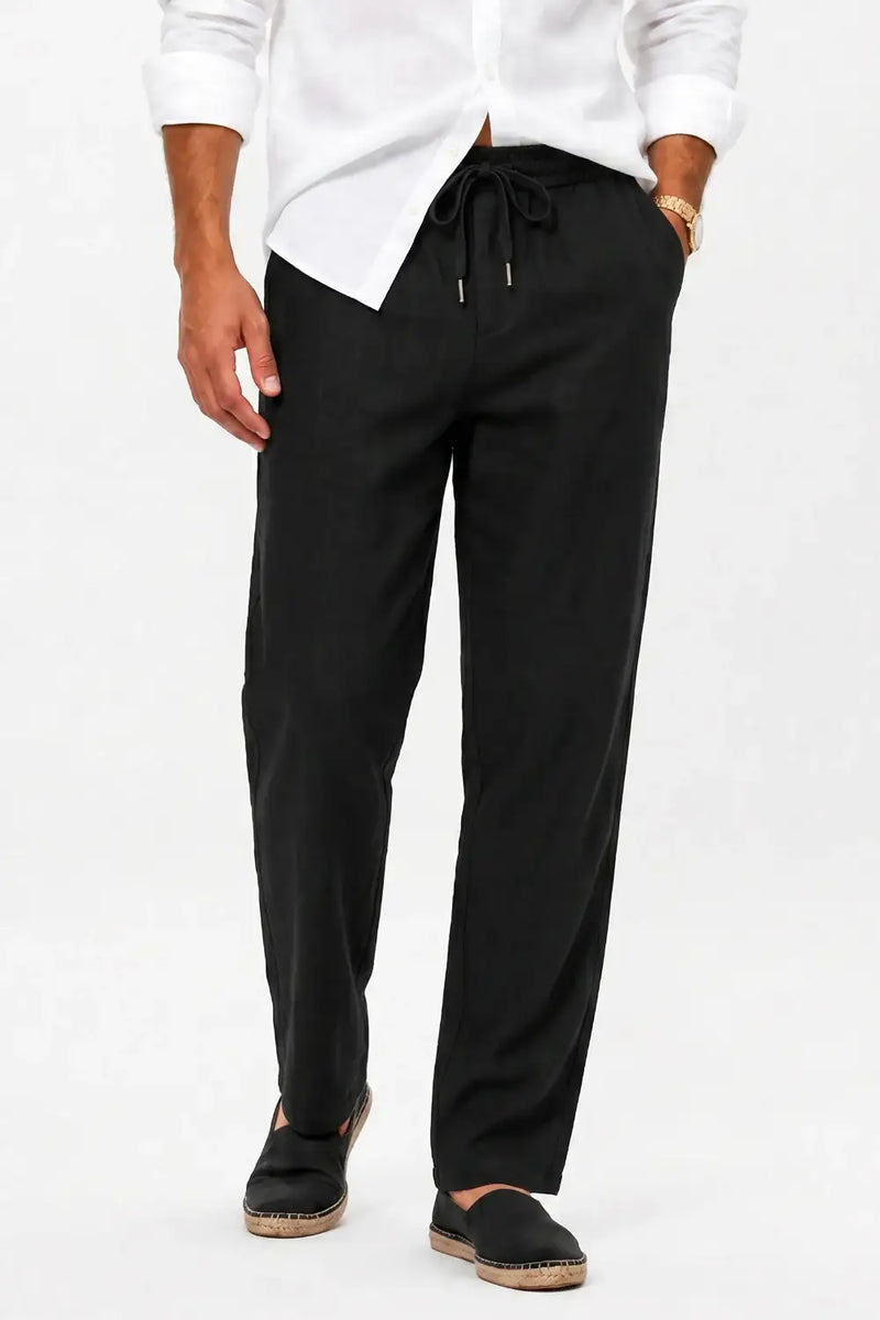 Black drawstring waist chinos with relaxed fit, paired with white shirt and espadrilles for casual style