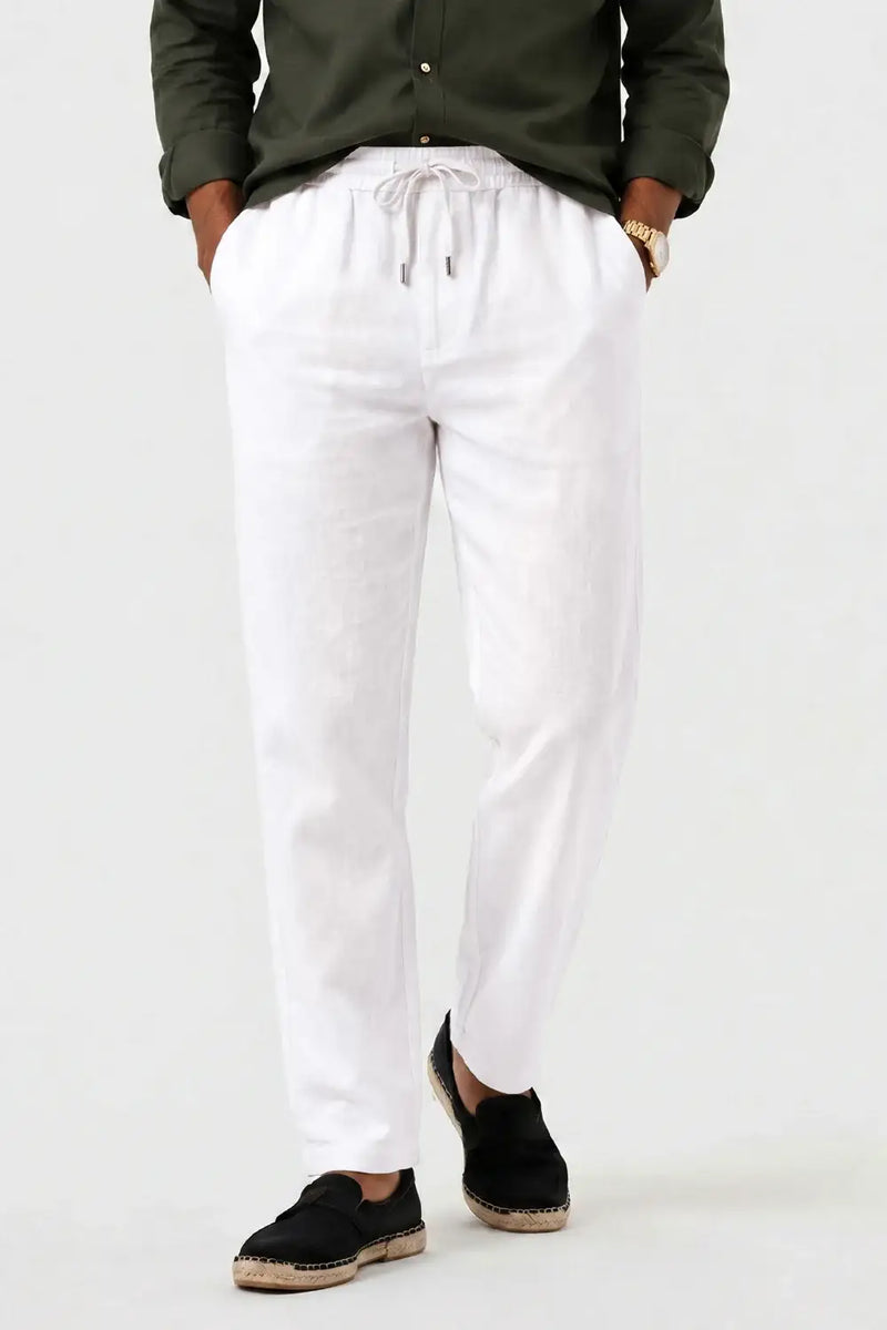 White drawstring waist linen pants with relaxed fit, paired with olive shirt and espadrilles for casual comfort.