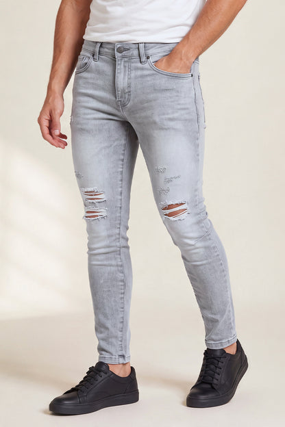 Jeans da uomo grigio marmo attillati lavati e strappati