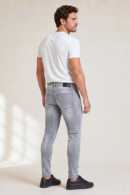 Jeans da uomo grigio marmo attillati lavati e strappati