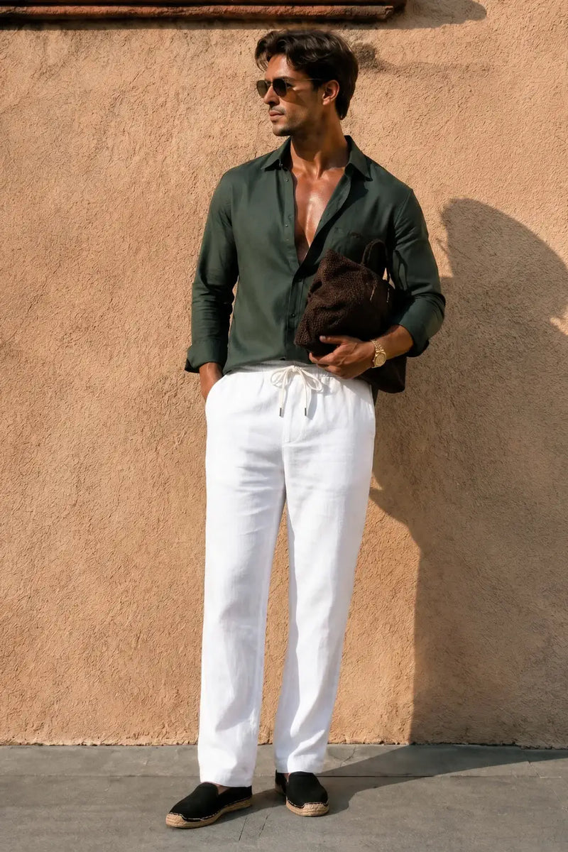 Man wearing white drawstring pants with green shirt, stylish casual outfit for summer comfort and fashion